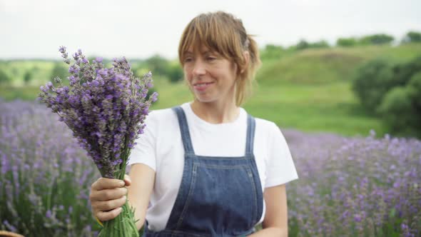 Rack Focus From Bouquet of Lavender to Smiling Happy Gardener Looking at Camera