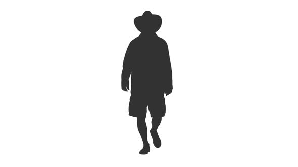 Silhouette of Male Walking in Shorts and Cowboy Hat