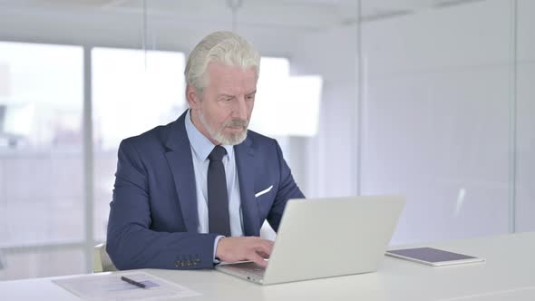 Old Businessman Working on Laptop