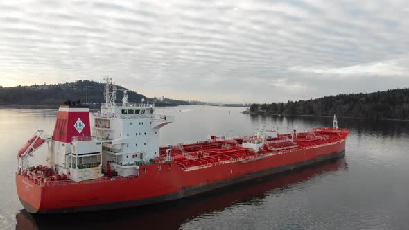 Drone shot of a petrol tanker and small boat on a cloudy winter day.