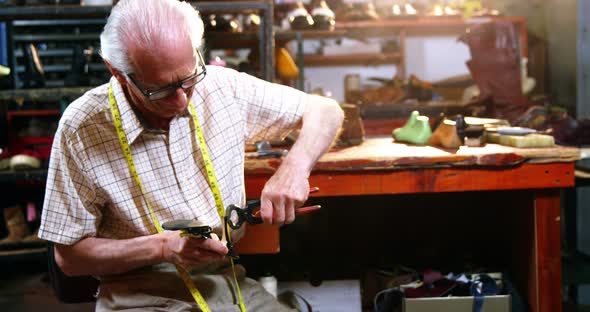 Shoemaker repairing a high heel