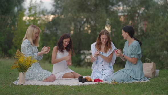 A Group of Young Women in Nature Conduct a Master Class in Clay Modeling