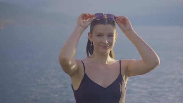 Beautiful smiling girl in a mountain lake