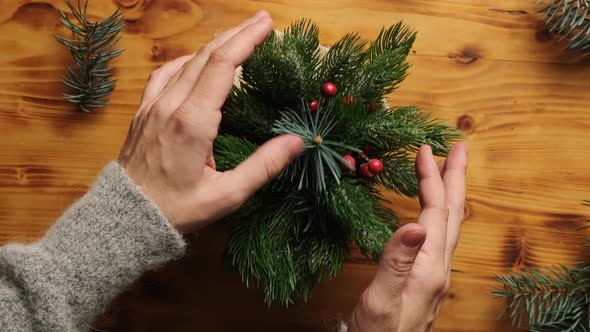 Female Hands Makes Christmas Ikebana