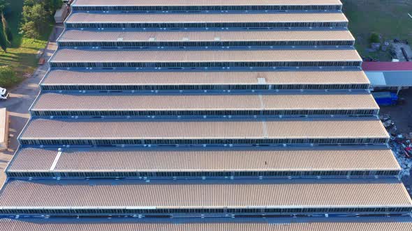 Saw-tooth pattern metal roof of a big factory in a production plant - abstract. Ridges on rooftop.