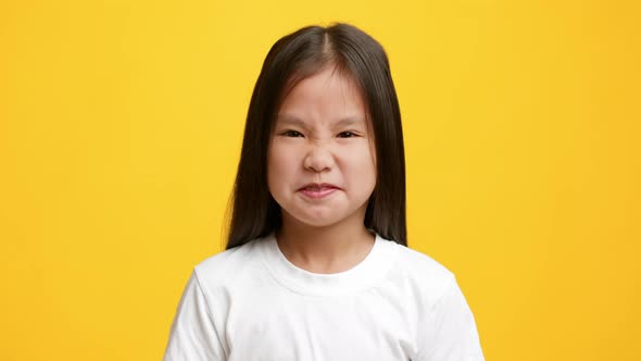 Disgusted Japanese Girl Pinching Nose Smelling Unpleasant Smell Yellow Background