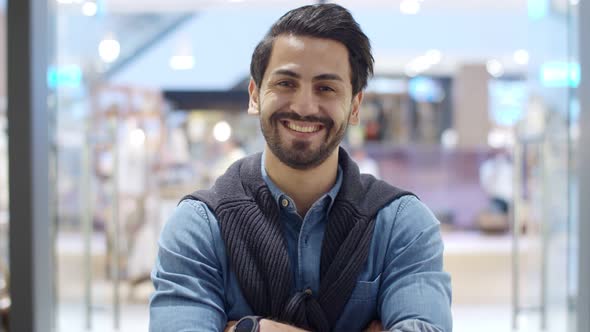 Portrait young Middle East man at modern musical instrument store