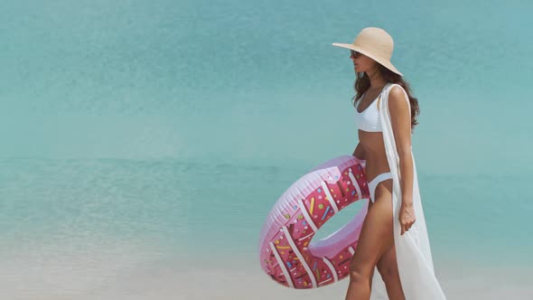 Woman on the Beach with a Rubber Ring