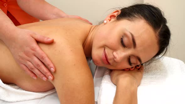 Masseur Massages Woman's Back