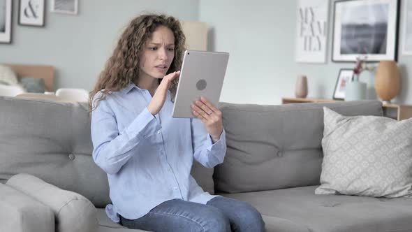 Curly Hair Woman in Shock By Loss While Using Tablet