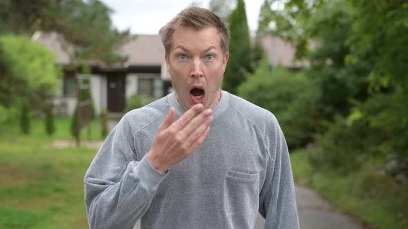 Young Handsome Man Looking Surprised And Covering Mouth At Home Outdoors