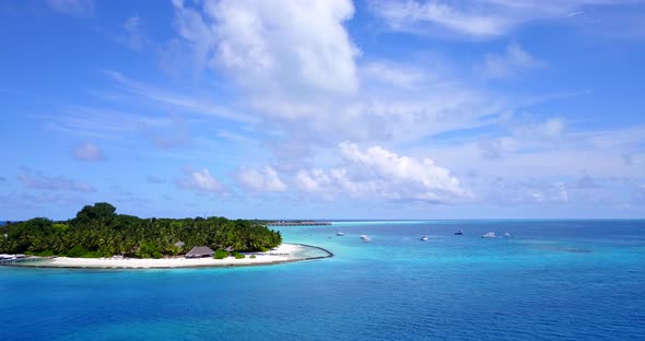 Daytime aerial tourism shot of a summer white paradise sand beach and aqua blue ocean background in 
