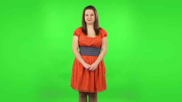 Funny Girl Is Smiling Broadly and Winking. Green Screen