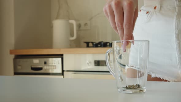 Closeup Shot of a Woman is Pouring Tea Into a Cup