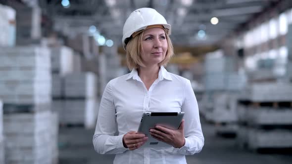 Follow Footage of Employees Famale Warehouse Worker Engineer in Hard Hat Working