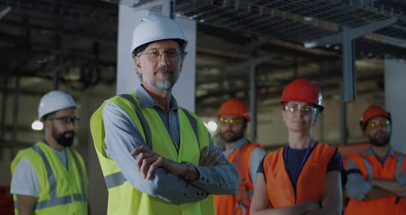 Confident Mature Foreman Near Female Colleague