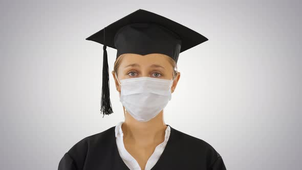 Graduate Student Lady in a Medical Mask Looking To Camera on Gradient Background