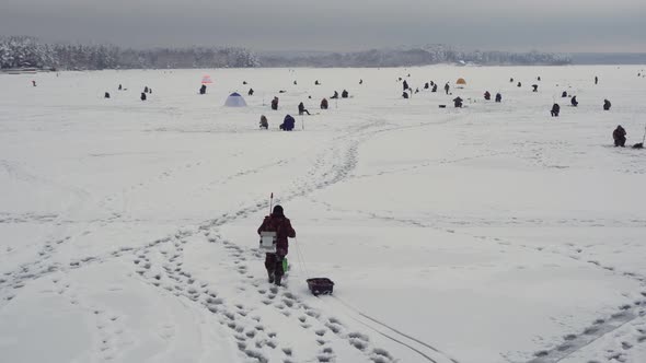 Fisherman Walks on Frozen Lake Winter Fishing Championship Snowy Lake