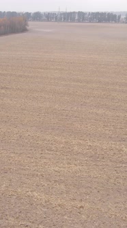 Vertical Video of a Field with Plowed Land in Autumn Slow Motion