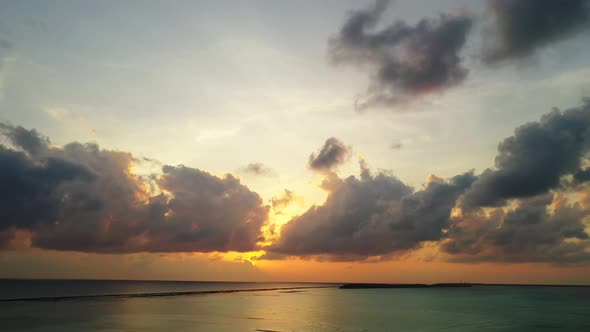 Beautiful above travel shot of a paradise sunny white sand beach and blue ocean background in vibran