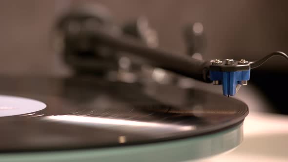 Close Up Hand Turning on Vintage Record Player
