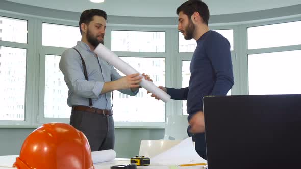 Two Architects Shake Hands at the Office