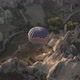 Hot Air Balloon with Tourist Basket Flies Over Stone Pillars - VideoHive Item for Sale