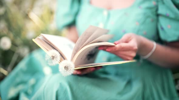 Woman Flips Through Pages of Paper Book