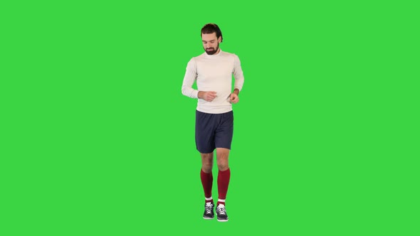 Football Player in Jogging or Running on a Green Screen Chroma Key