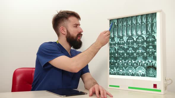 Physiotherapist Shows Patient an Xray Image of Skeleton of Bones