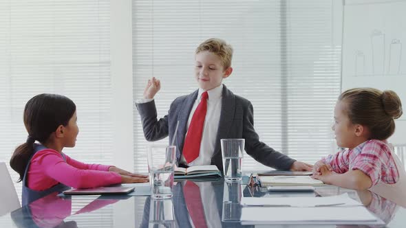 Kids as business executives having a meeting in the board room 4K 4k