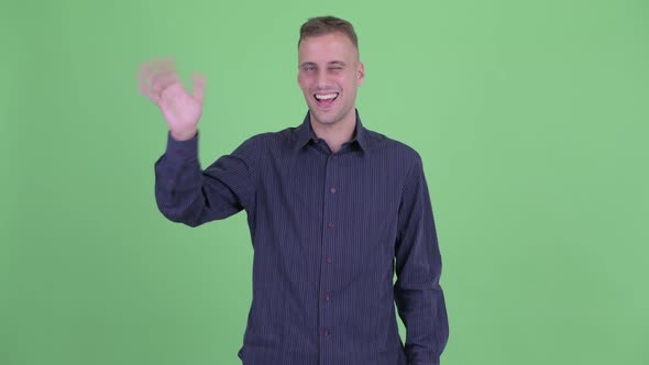 Happy Handsome Businessman Waving Hand