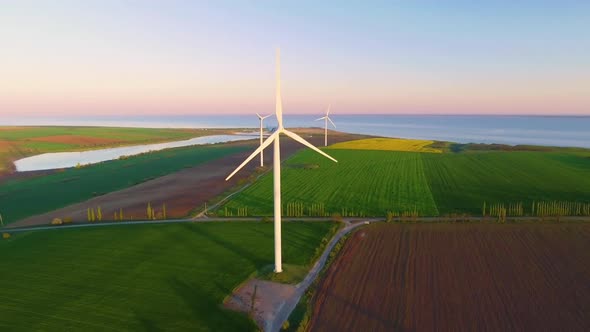 Wind Turbine Farm on Beautiful Evening Landscape. Renewable Energy Production for Green Ecological