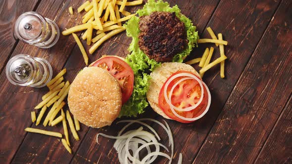 Two Tasty Grilled Home Made Burgers with Beef, Tomato, Onion and Lettuce