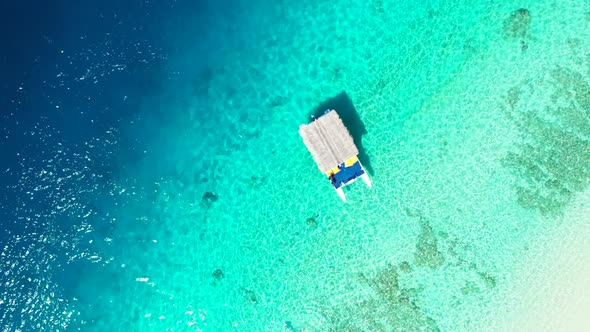 Aerial drone shot seascape of relaxing coastline beach journey by blue lagoon with clean sandy backg