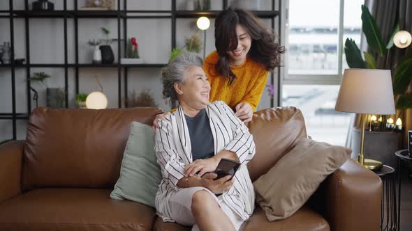 Portrait Asian family cuddling in sofa living room at home.