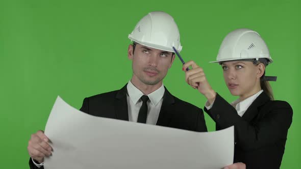 Happy Female Engineer Explaining Blueprint to Male Engineer Chroma Key