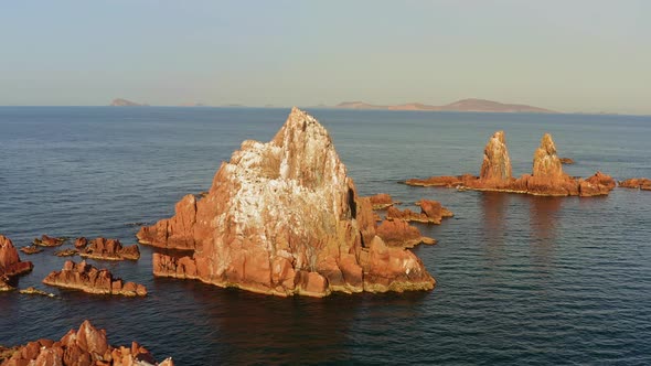 Beautiful Vertical Rocks Sticking Out of the Water at Dawn