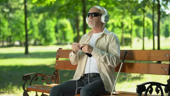 Blind Man Plugging Headset in Phone, Saying Voice Commands to Call or Message