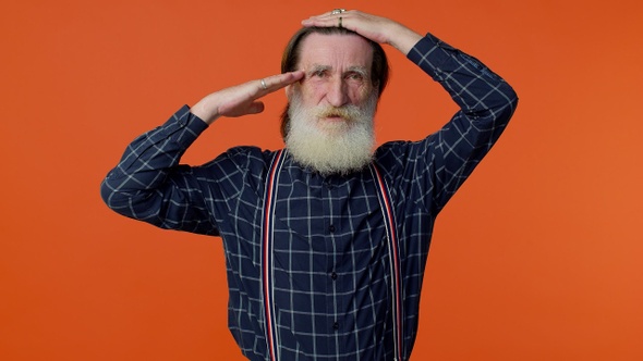 Mature Old Grandfather Giving Salute Listening to Order As If Soldier Following Discipline Obeying