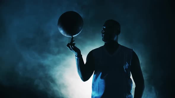 Basketball is Being Spinned on a Finger By an Africanamerican Athlete