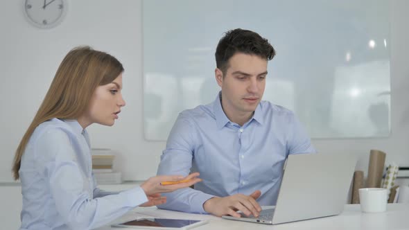 Young Business Colleague Explaining Online Project on Laptop