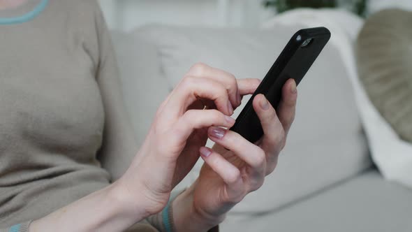 Young Woman Customer Holding Phone in Hands Shopping in App Checking Social Media Enjoy Online Chat