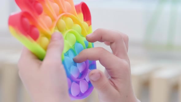 Child Play with Pop It Sensory Toy