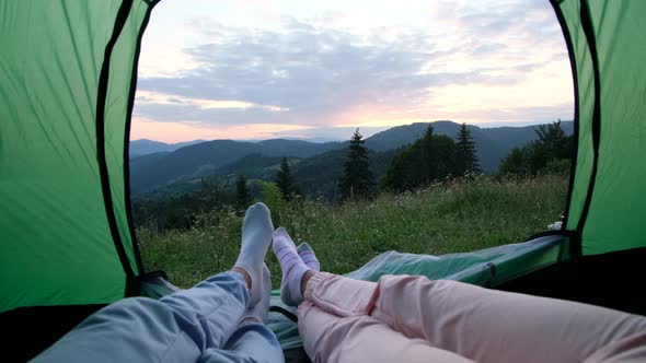 The Guy and the Girl are Tourists They are Resting in a Tent on Top of the Mountain