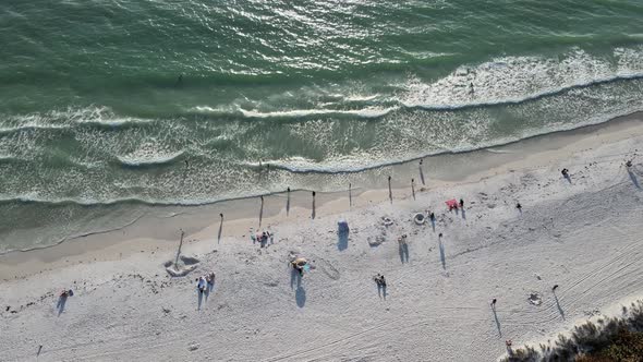 waves, sun and fun during sundown on Cortez Beach in Bradenton, Florida in the aerial drone view