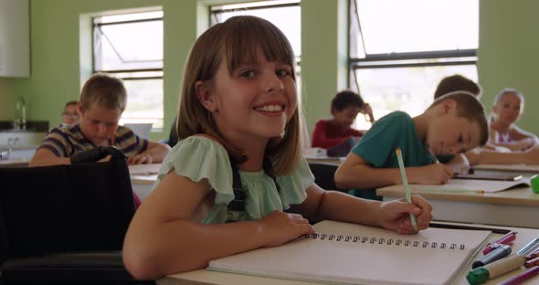 Physically challenged girl smiling in the class