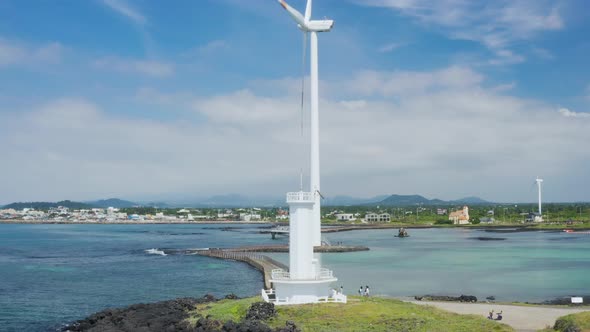 Landscape with blue sea and sky, wind turbine. Drone view. Jeju Island.