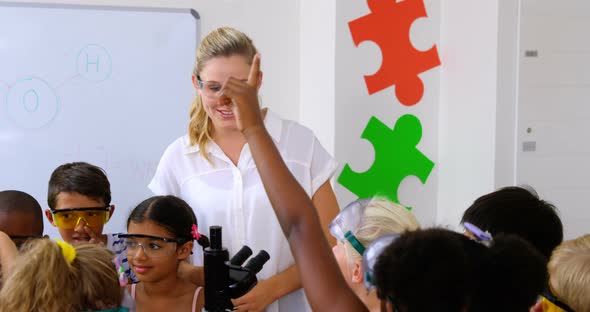 School kids raising hand in laboratory