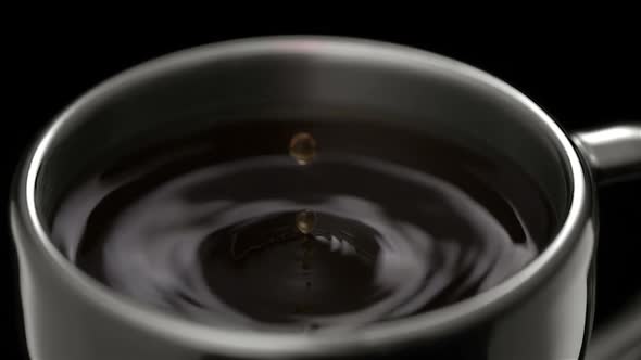 Coffee drop making ripple in cup, Slow Motion alt